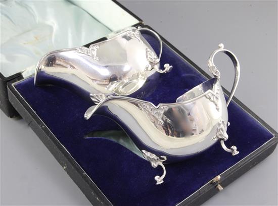A cased pair of George V silver sauce boats, by Walker & Hall, Length 161mm weight 9.5oz/296grms